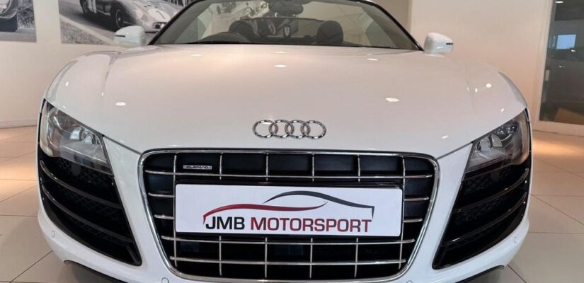 010 Audi R8 5.2 FSI V10 Spyder showcasing its sleek design and iconic grille.