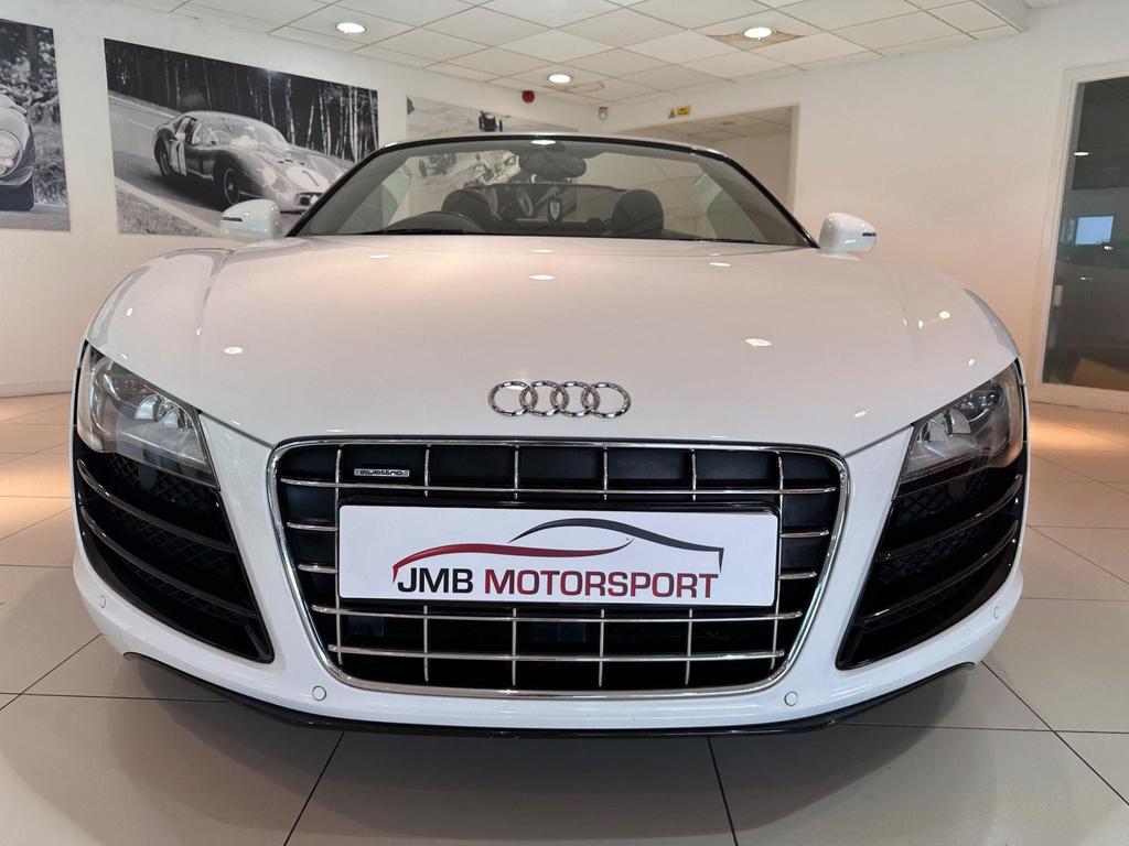 010 Audi R8 5.2 FSI V10 Spyder showcasing its sleek design and iconic grille.