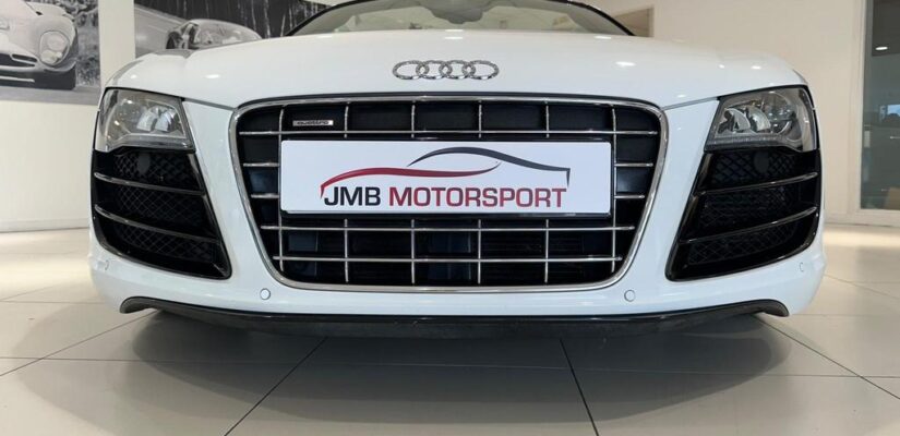 010 Audi R8 5.2 FSI V10 Spyder showcasing its sleek design and iconic grille.