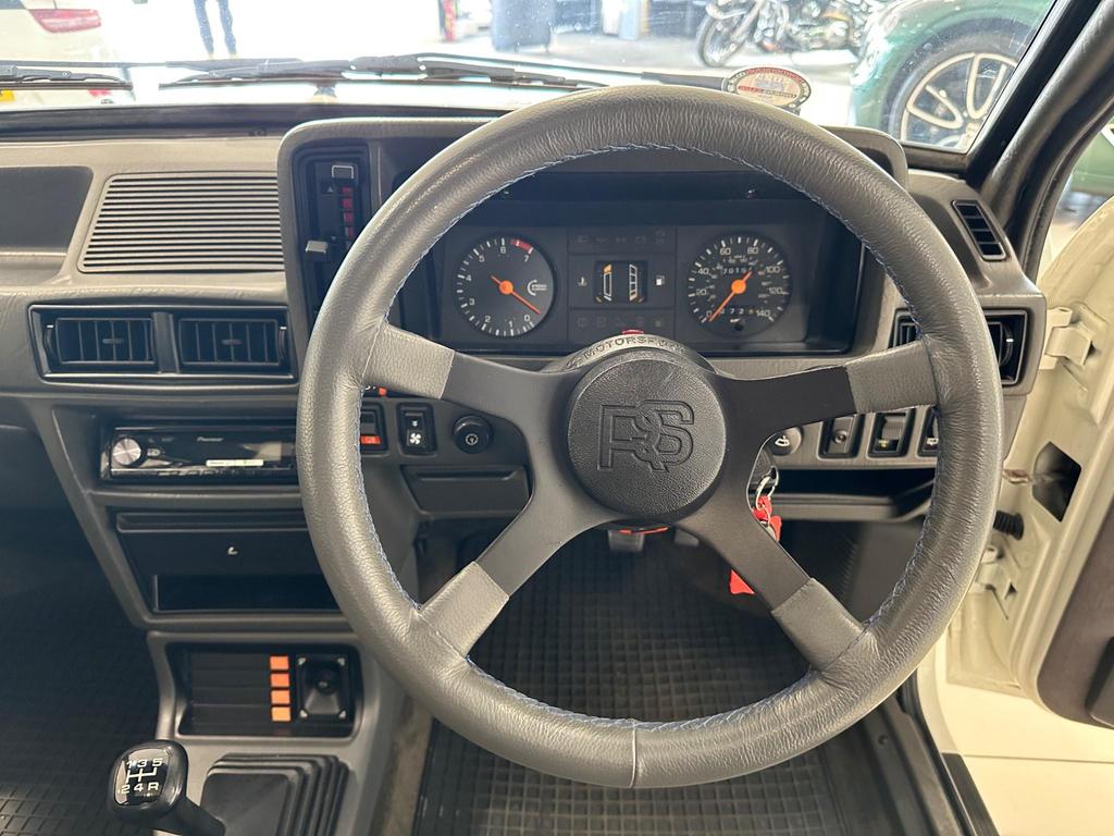The indigo cloth interior of the 1985 Ford Escort 1.6 Turbo RS, showing its classic sports seats and vintage design.