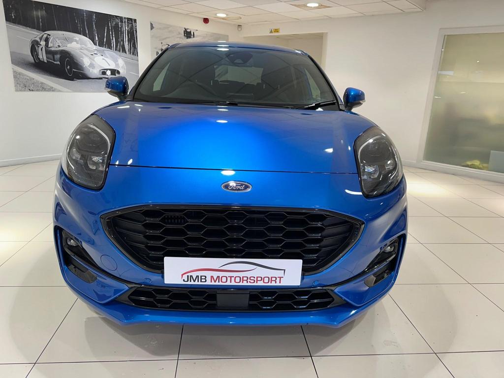 The Ford Puma ST-Line X exterior showcasing its sporty design, alloy wheels, and large rear spoiler.