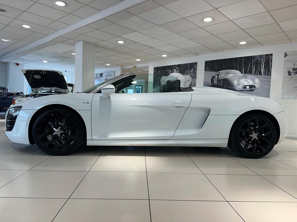 010 Audi R8 5.2 FSI V10 Spyder showcasing its sleek design and iconic grille.