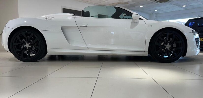 010 Audi R8 5.2 FSI V10 Spyder showcasing its sleek design and iconic grille.