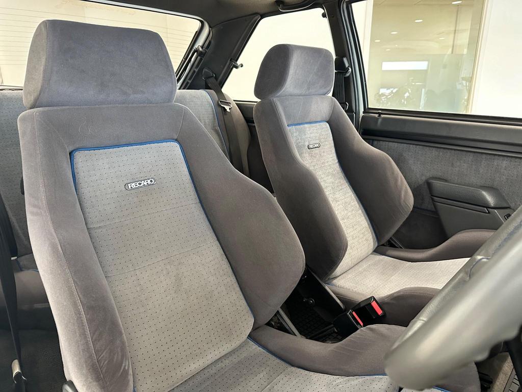 The indigo cloth interior of the 1985 Ford Escort 1.6 Turbo RS, showing its classic sports seats and vintage design.