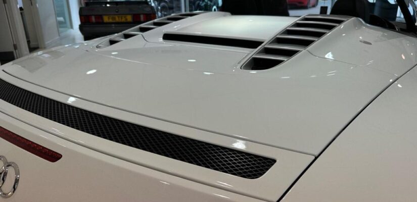 010 Audi R8 5.2 FSI V10 Spyder showcasing its sleek design and iconic grille.