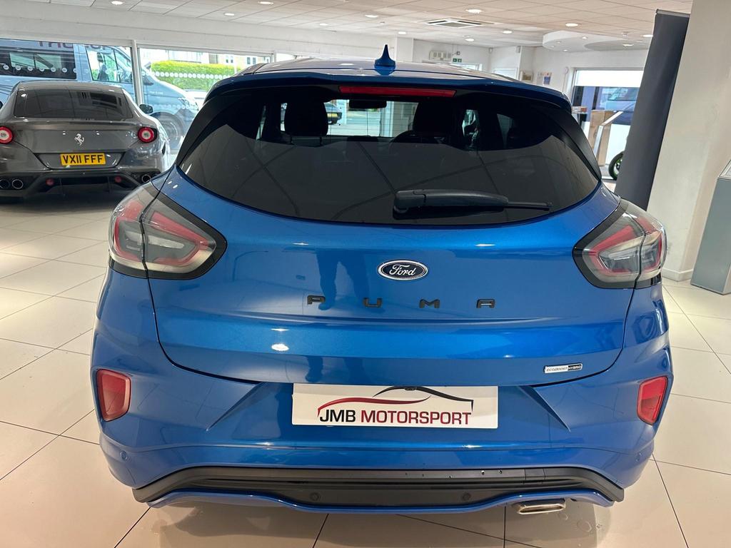 The Ford Puma ST-Line X exterior showcasing its sporty design, alloy wheels, and large rear spoiler.