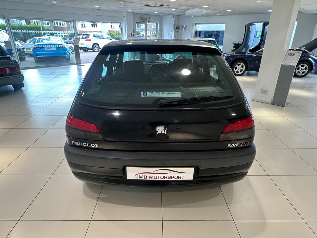Front view of the 1998 sedan with metallic paint and alloy wheels, showcasing its classic design.