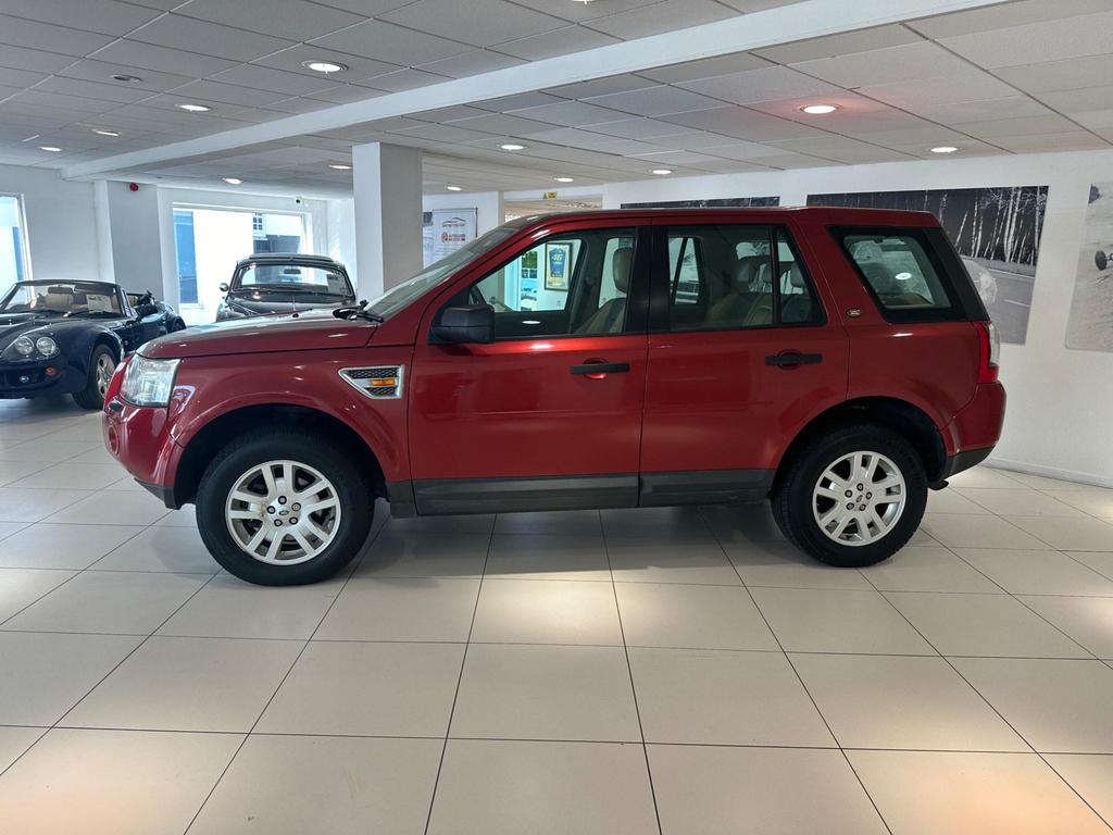 Front view of the 2007 Land Rover Freelander in vibrant red, showcasing its rugged design and excellent condition.