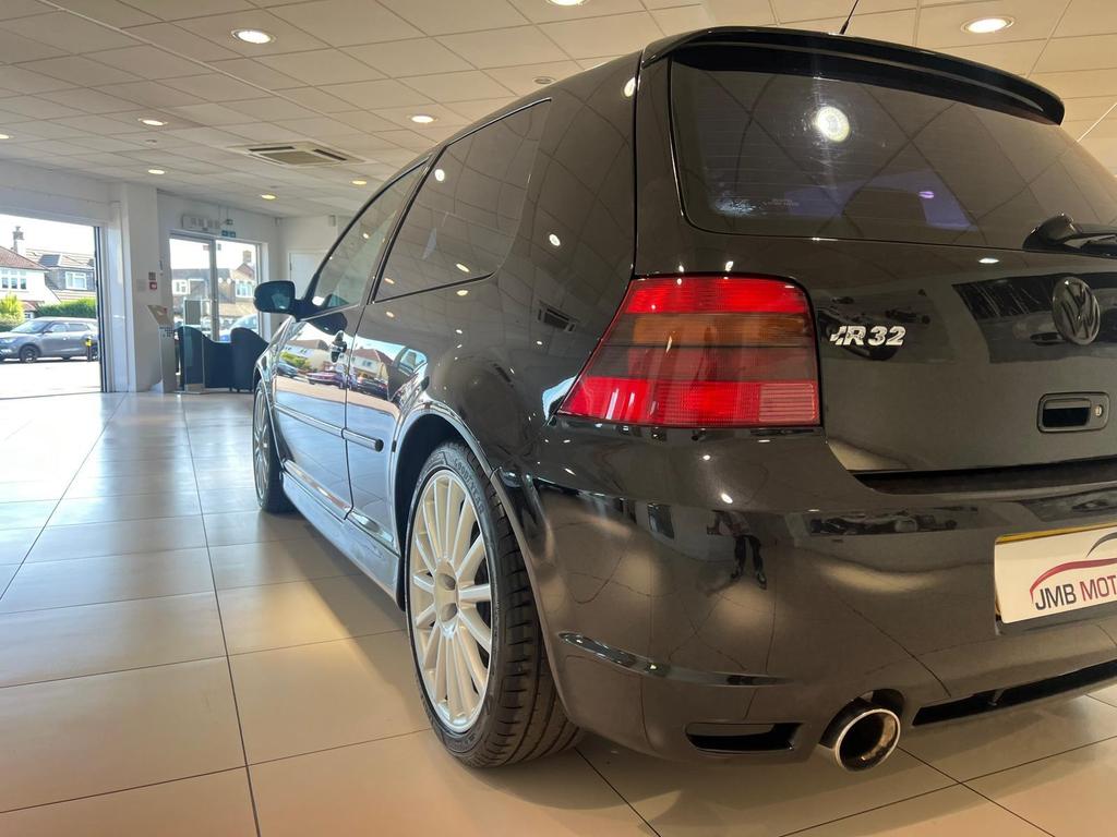 Front view of the fully restored VW R32 in sleek black, showcasing its pristine condition and classic design.