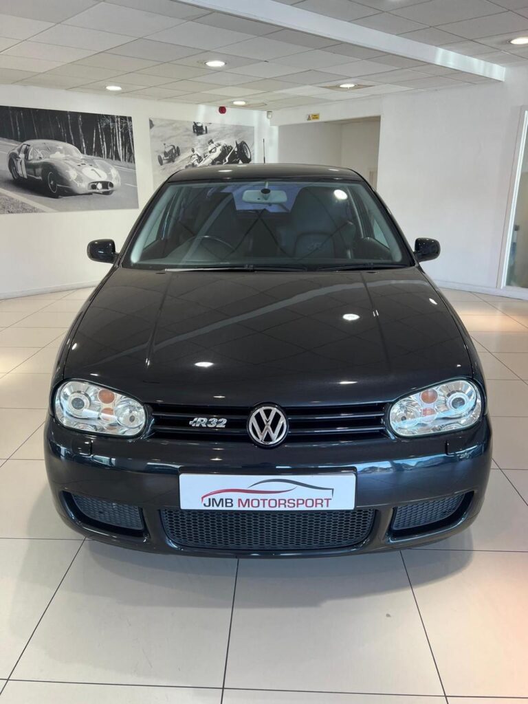 Front view of the fully restored VW R32 in sleek black, showcasing its pristine condition and classic design.
