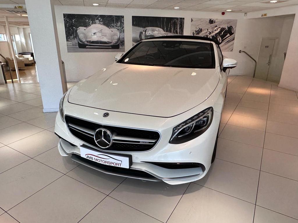 Front view of the Mercedes S63 AMG Premium Plus showcasing its sleek white exterior and AMG bodystyling.