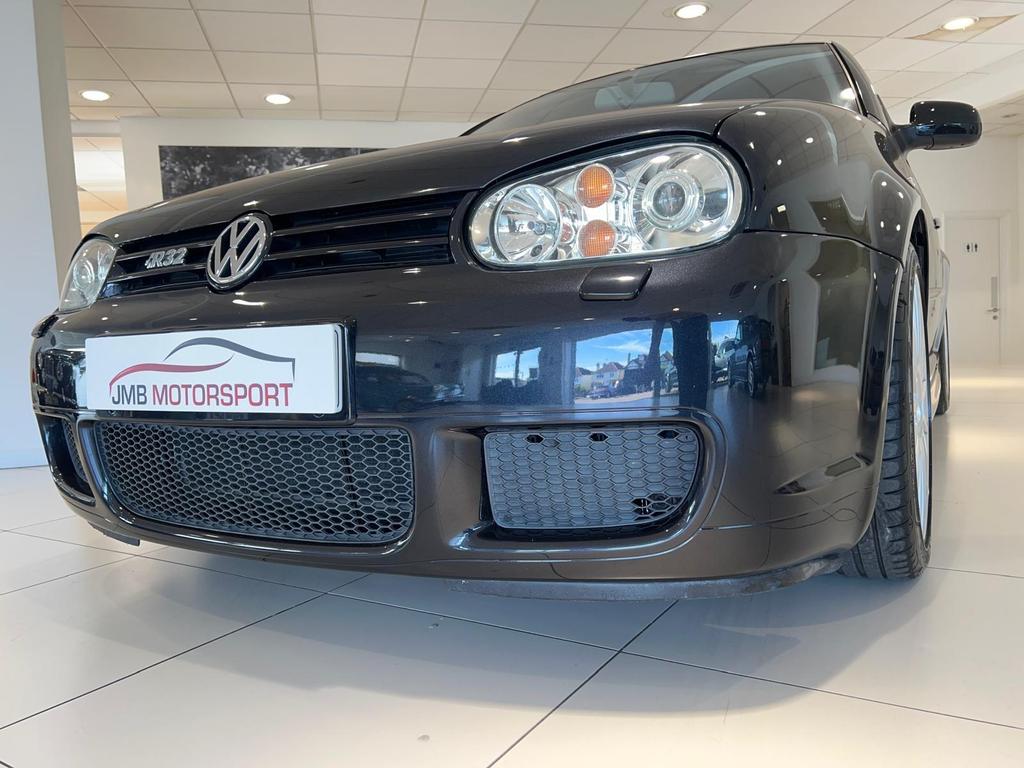Front view of the fully restored VW R32 in sleek black, showcasing its pristine condition and classic design.