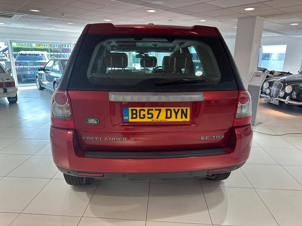 Front view of the 2007 Land Rover Freelander in vibrant red, showcasing its rugged design and excellent condition.