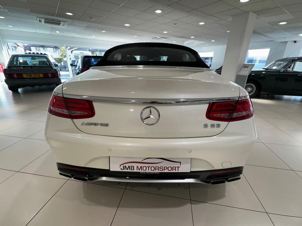 Front view of the Mercedes S63 AMG Premium Plus showcasing its sleek white exterior and AMG bodystyling.