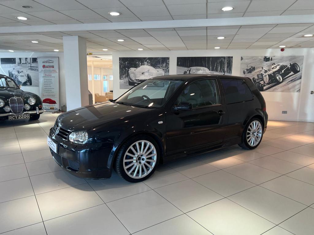 Front view of the fully restored VW R32 in sleek black, showcasing its pristine condition and classic design.