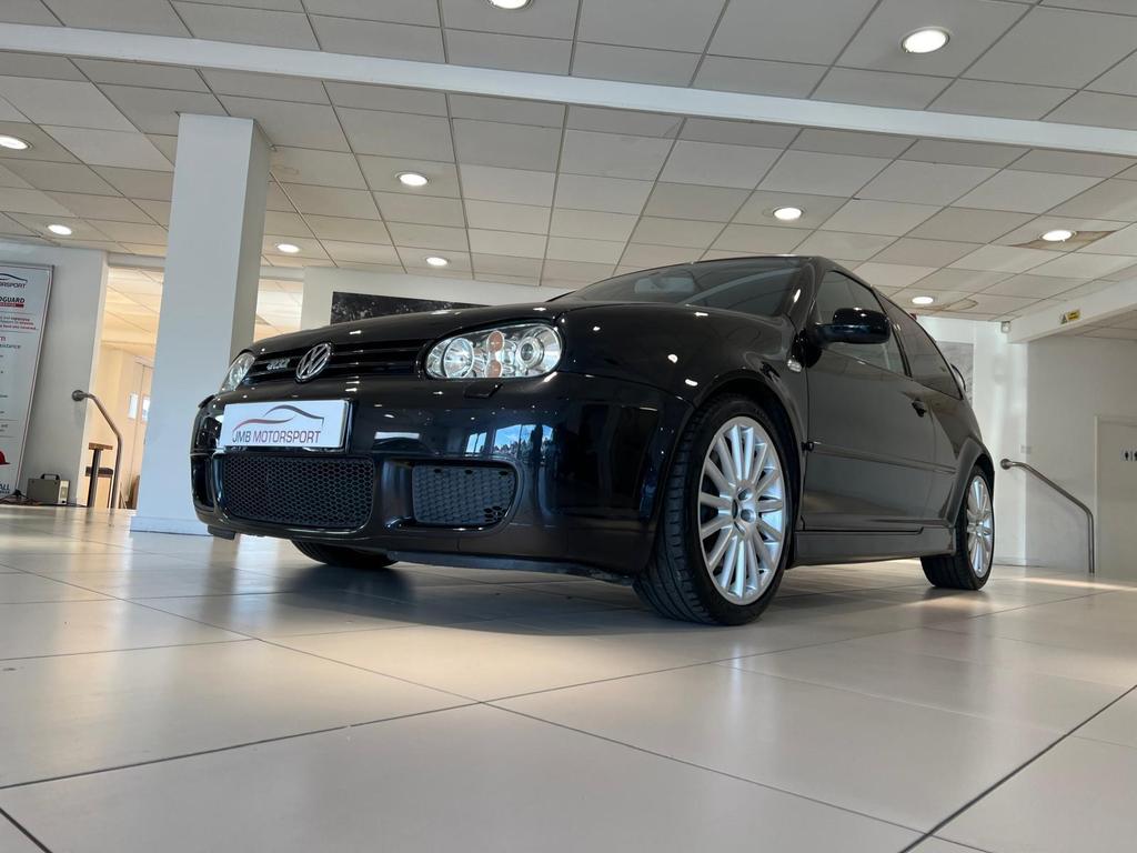 Front view of the fully restored VW R32 in sleek black, showcasing its pristine condition and classic design.