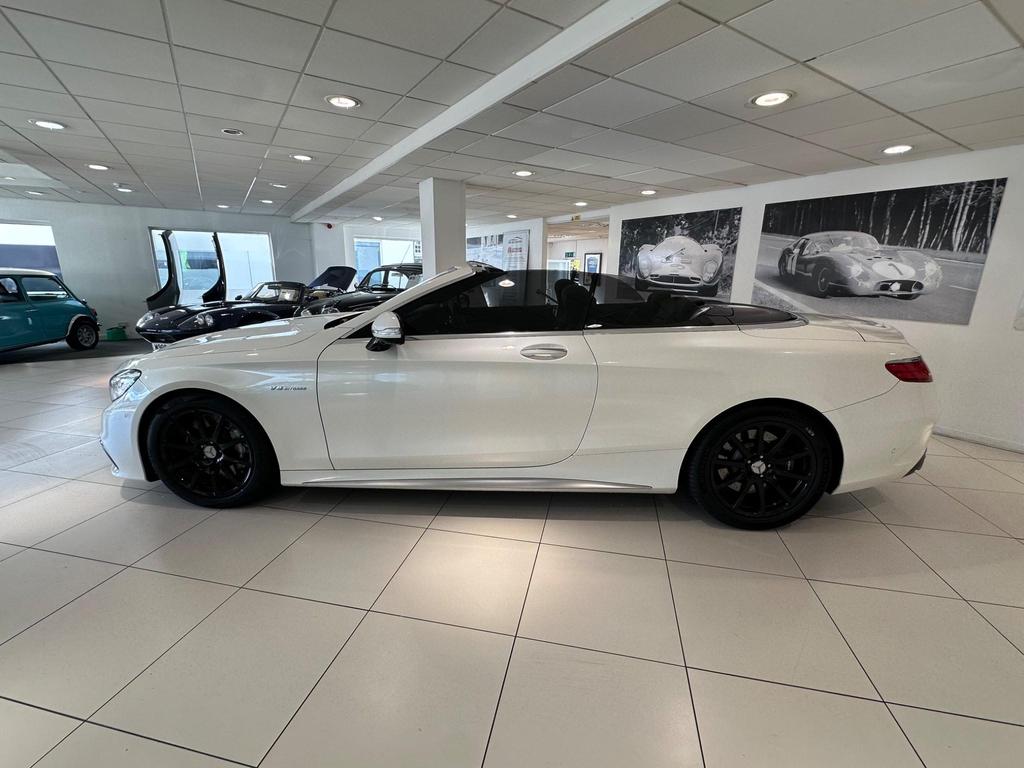 Front view of the Mercedes S63 AMG Premium Plus showcasing its sleek white exterior and AMG bodystyling.