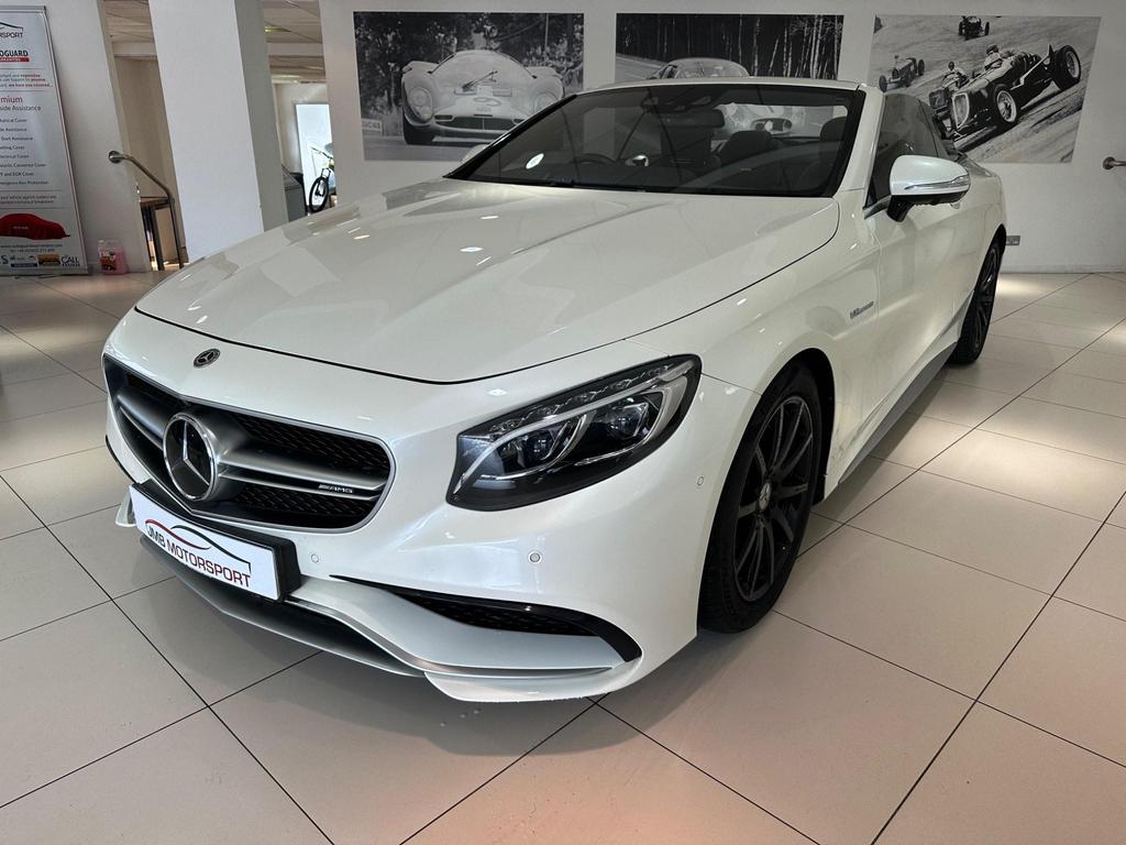 Front view of the Mercedes S63 AMG Premium Plus showcasing its sleek white exterior and AMG bodystyling.