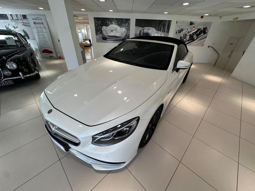 Front view of the Mercedes S63 AMG Premium Plus showcasing its sleek white exterior and AMG bodystyling.
